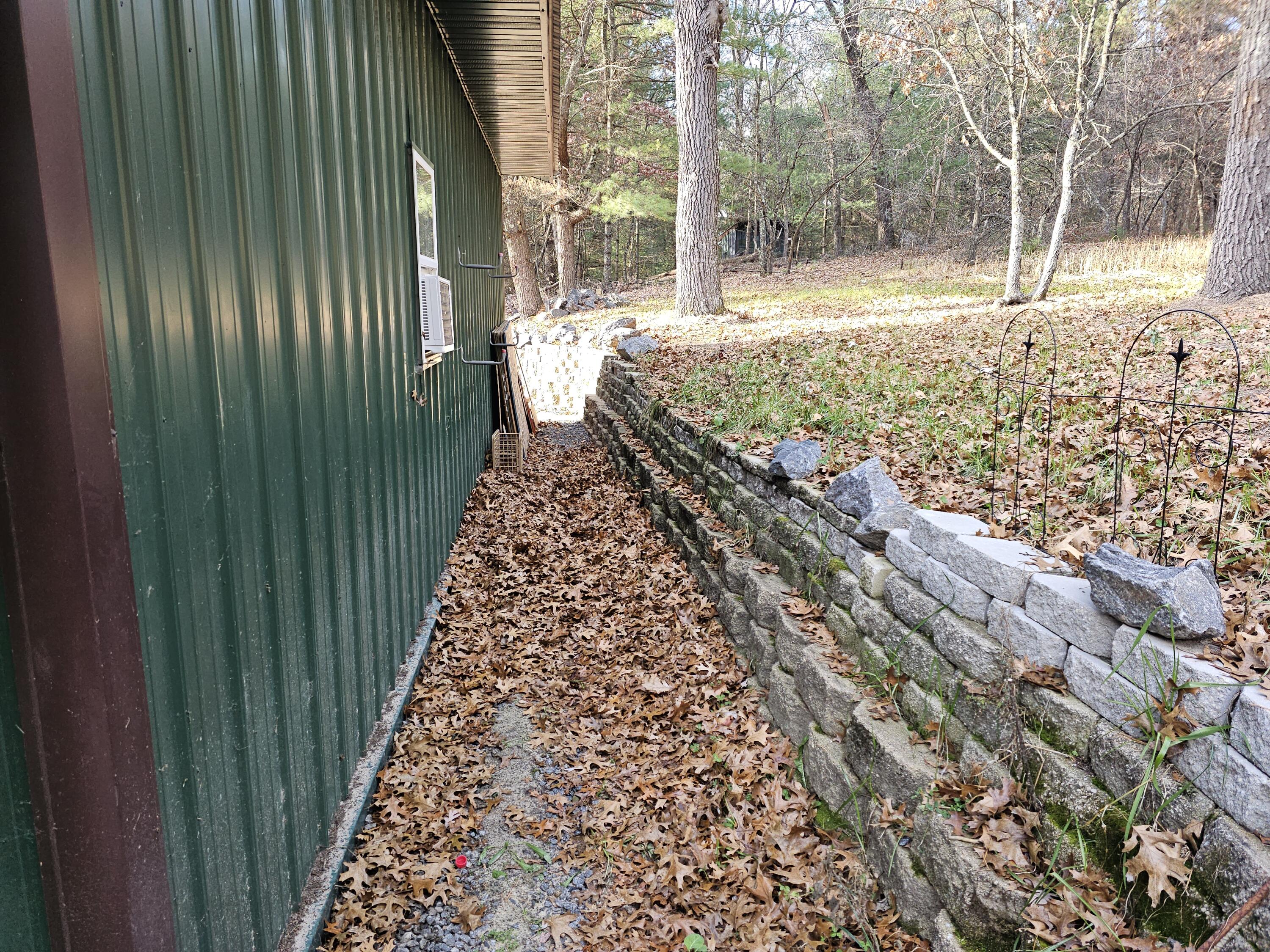 2026 Highway 71 Little Falls, WI 54656 - Photo 28 of 43 North side of garage retaining wall