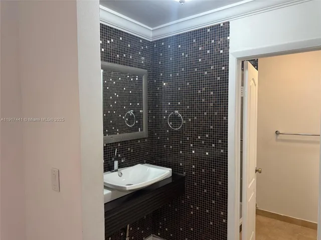 an empty room with white walls and tiles