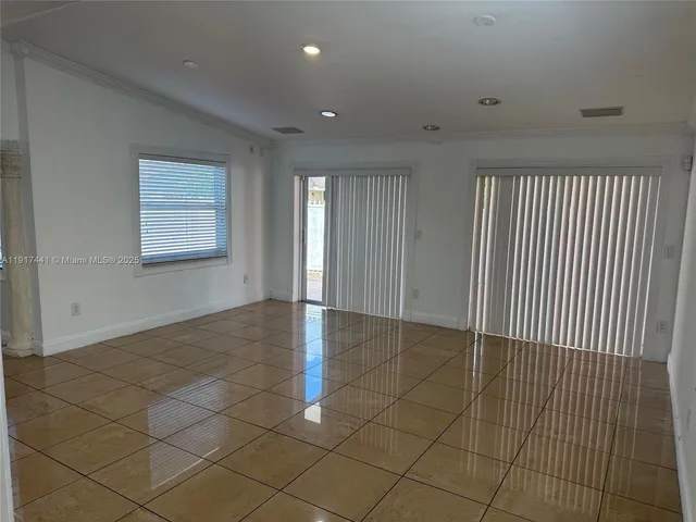 a kitchen with granite countertop a refrigerator and a stove top oven