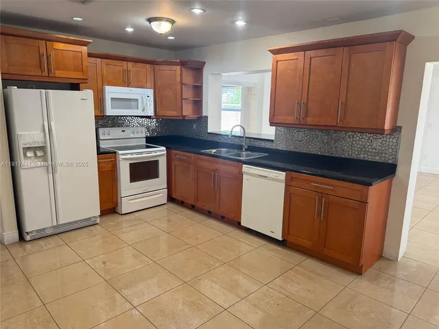a view of a hallway with washer and dryer