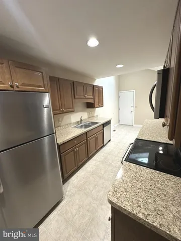 a kitchen with a refrigerator and a sink