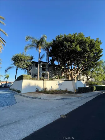 a view of a house with a tree next to a yard