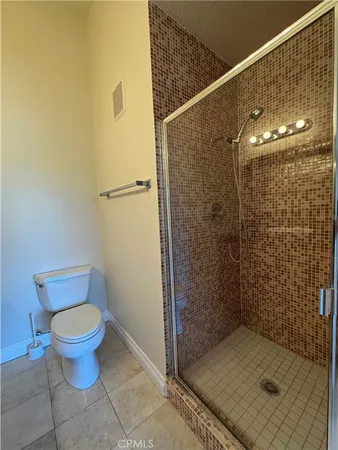 a bathroom with a shower and a toilet