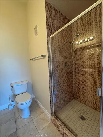 a bathroom with a shower and a toilet