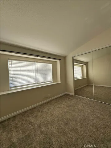 an empty room with a empty space and windows