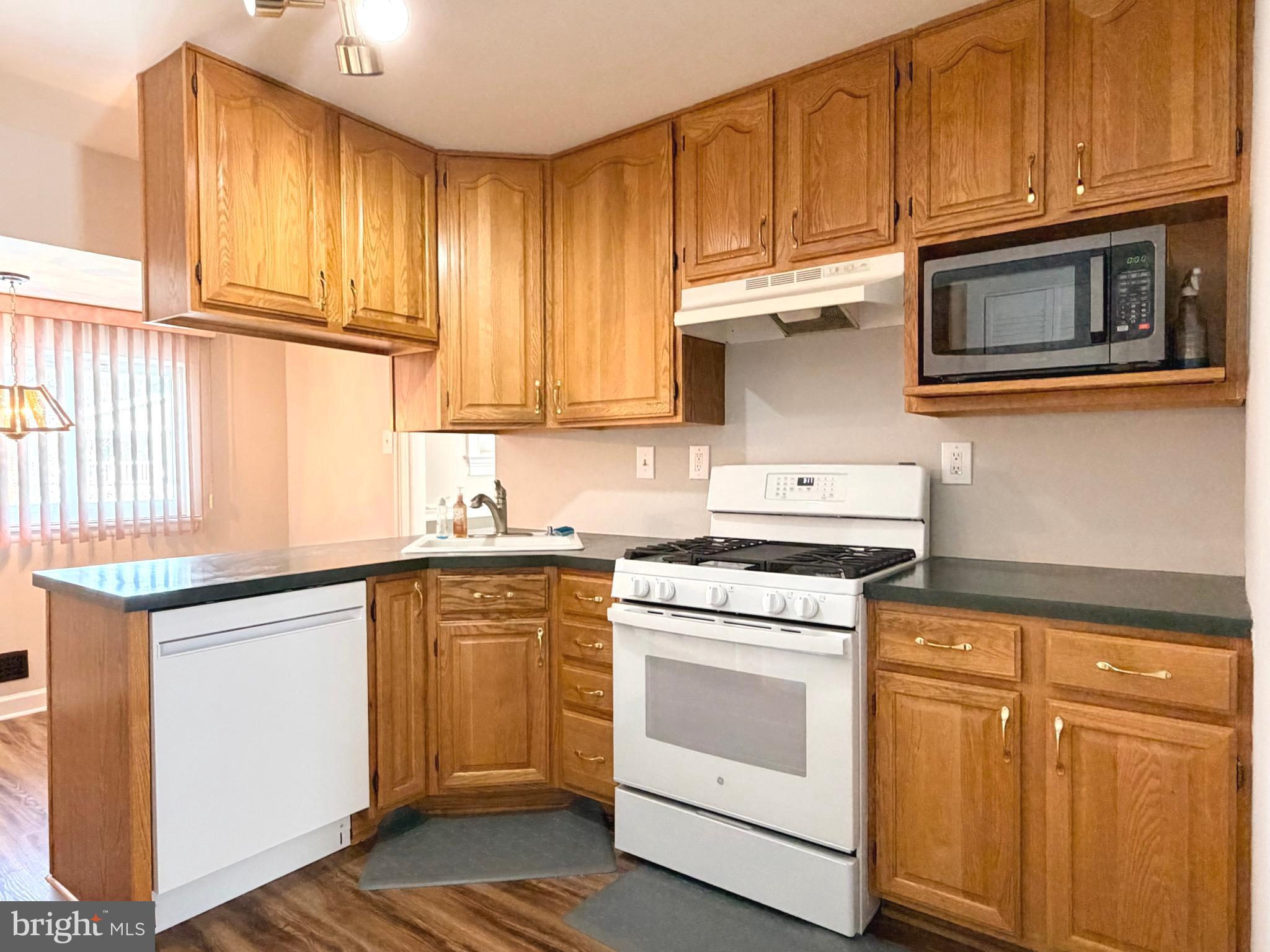 23 Lehigh Drive Delran, NJ 08075 - Photo 6 of 22 a kitchen with stainless steel appliances granite countertop a stove microwave and cabinets