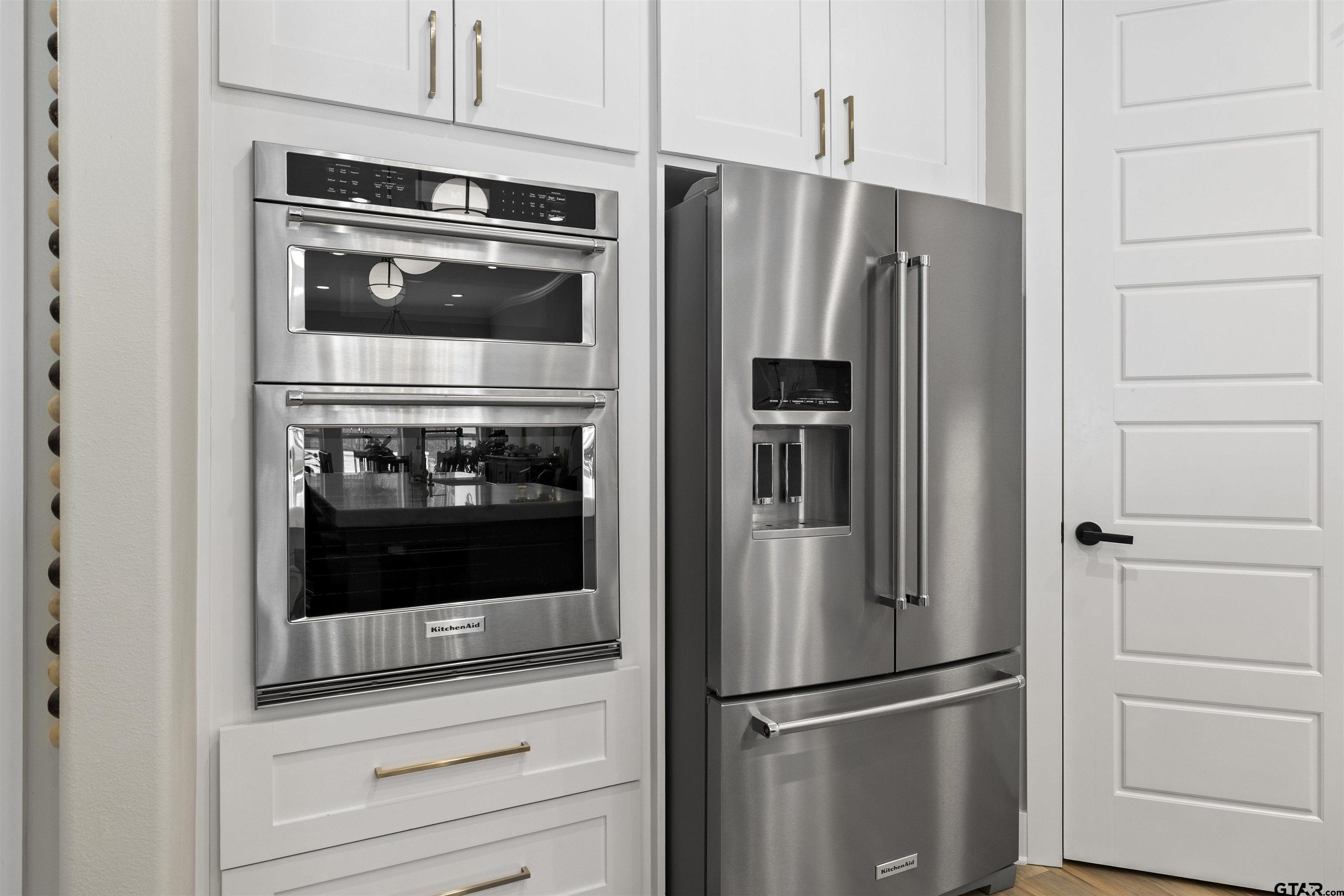 23316 Fm 1995 Lindale, TX 75771 - Photo 11 of 47 a metallic refrigerator freezer and a stove sitting inside of a kitchen