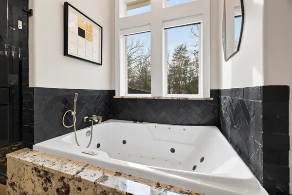 a bathroom with a granite countertop toilet sink and mirror
