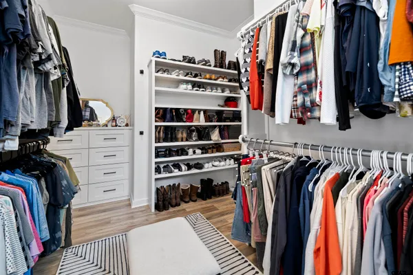 a bathroom with a granite countertop toilet a sink a mirror and a shower