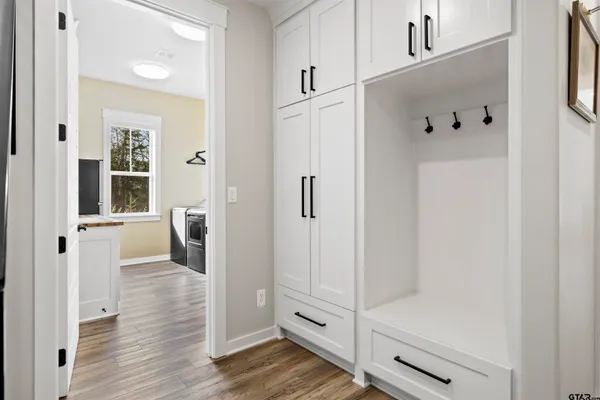 a view of a workspace with furniture and wooden floor
