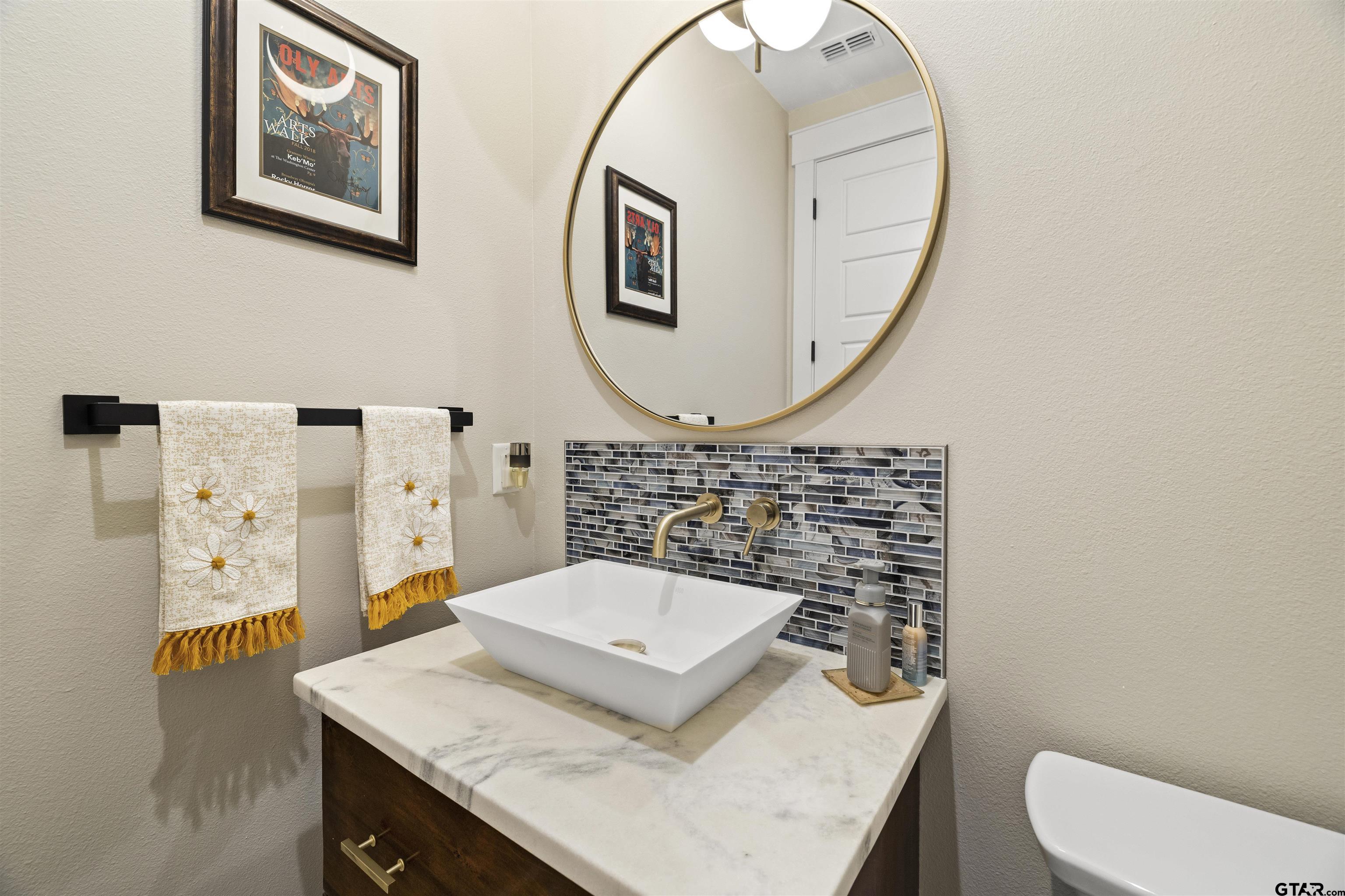 23316 Fm 1995 Lindale, TX 75771 - Photo 25 of 47 a bathroom with a granite countertop toilet sink and mirror