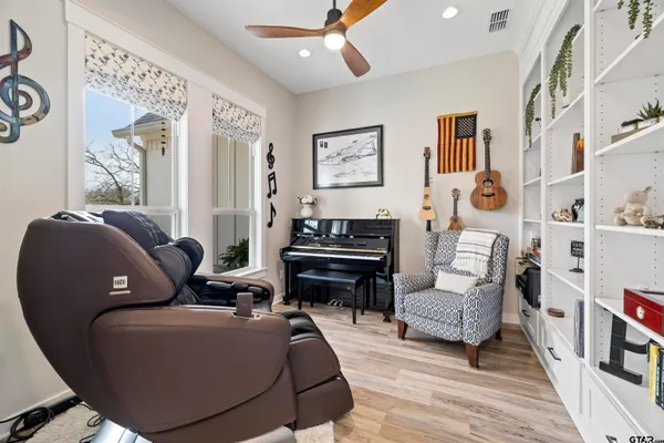 a kitchen with stainless steel appliances kitchen island granite countertop a table chairs microwave and sink