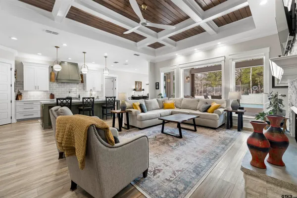 a metallic refrigerator freezer and a stove sitting inside of a kitchen