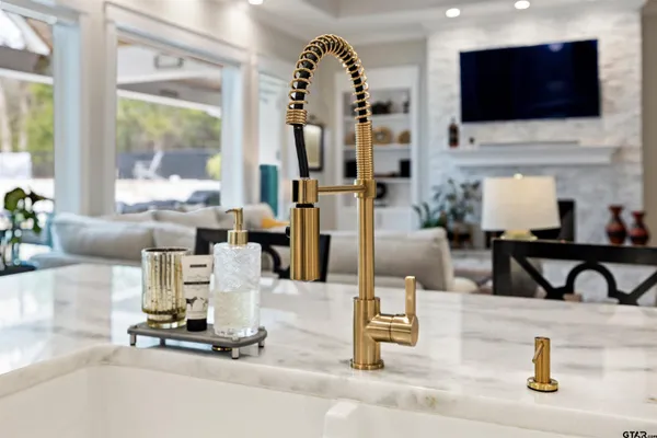 a large kitchen with stainless steel appliances granite countertop a lot of counter space and a sink