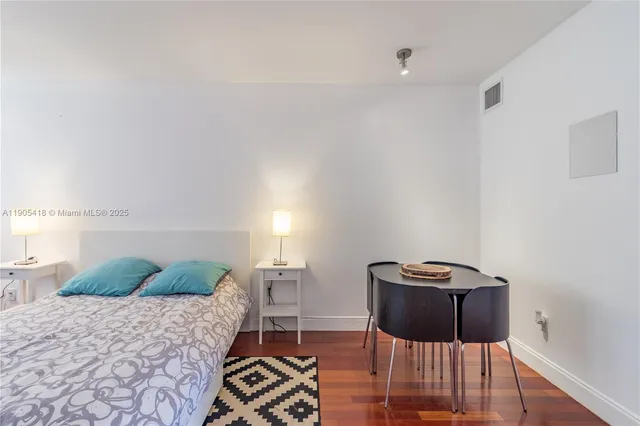 a bedroom with a bed and a flat screen television