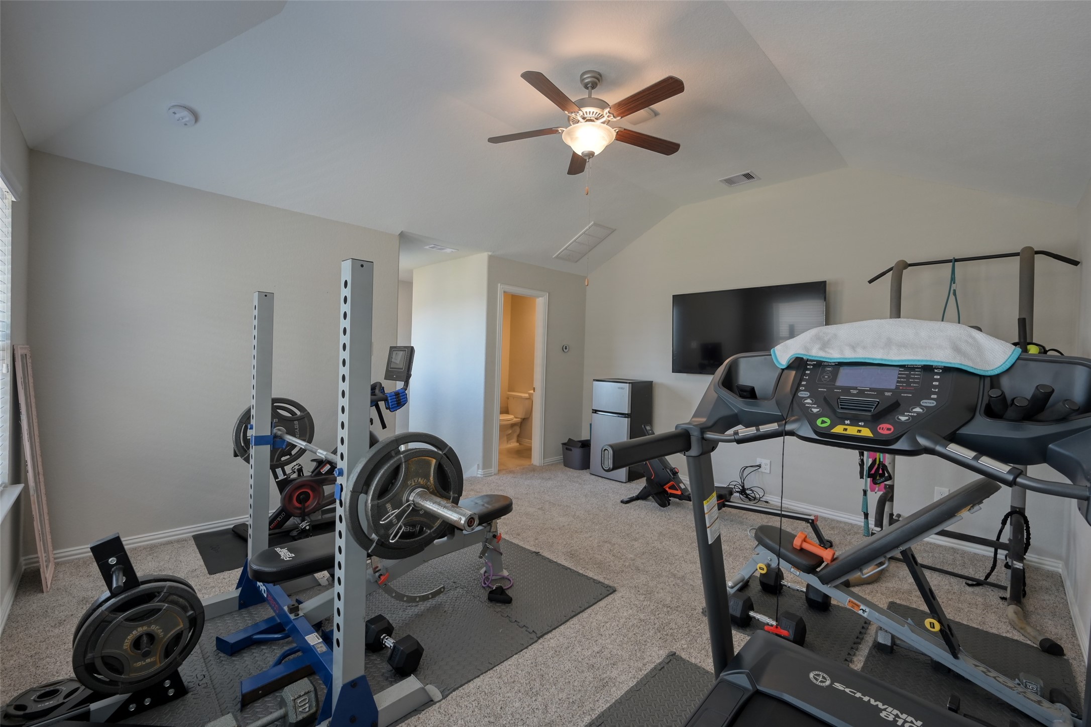 3465 Stablewood Grove Lane Spring, TX 77386 - Photo 30 of 50 a view of a workspace with furniture and a gym cycle