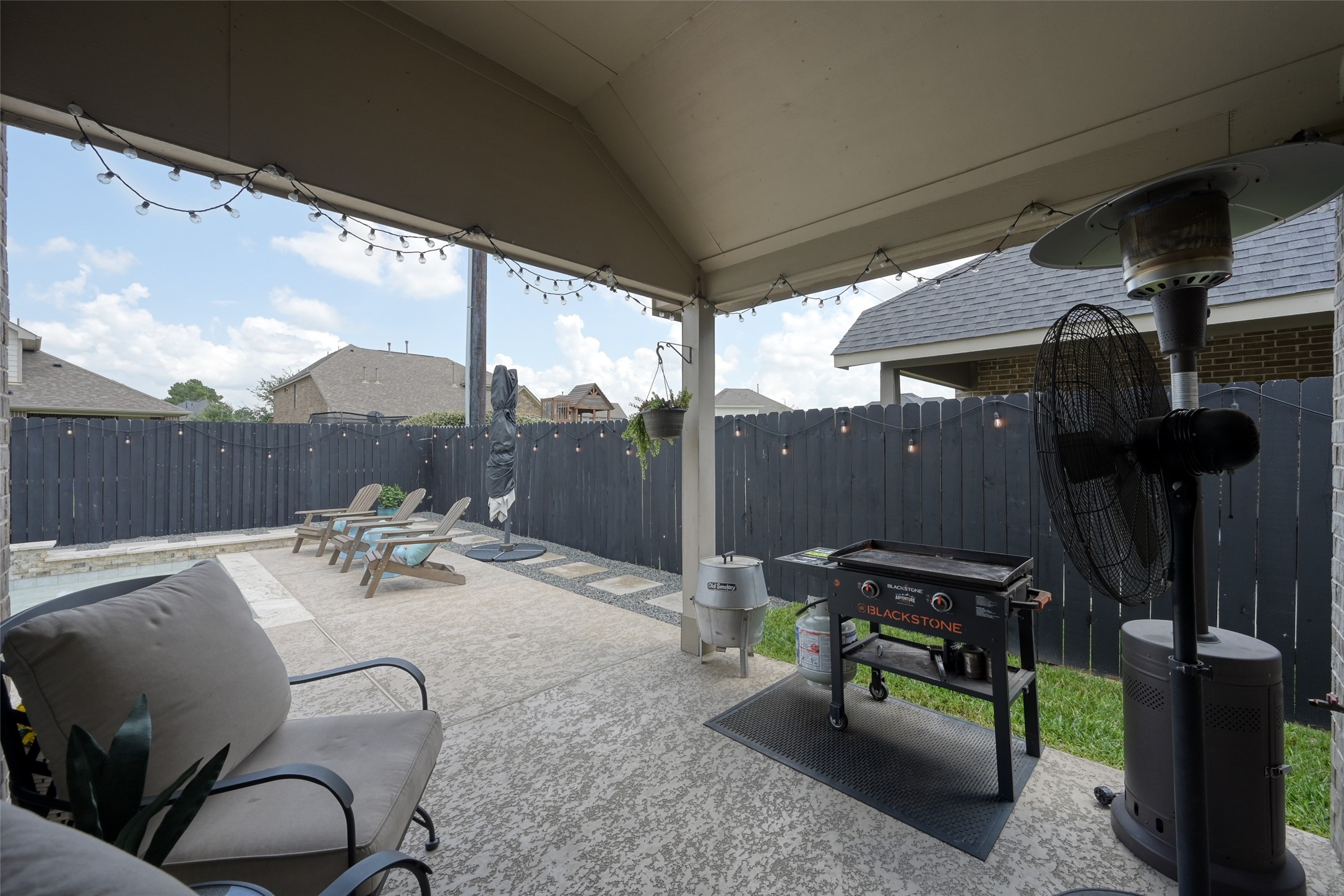 3465 Stablewood Grove Lane Spring, TX 77386 - Photo 32 of 50 a view of a patio with table and chairs a barbeque grill with wooden fence