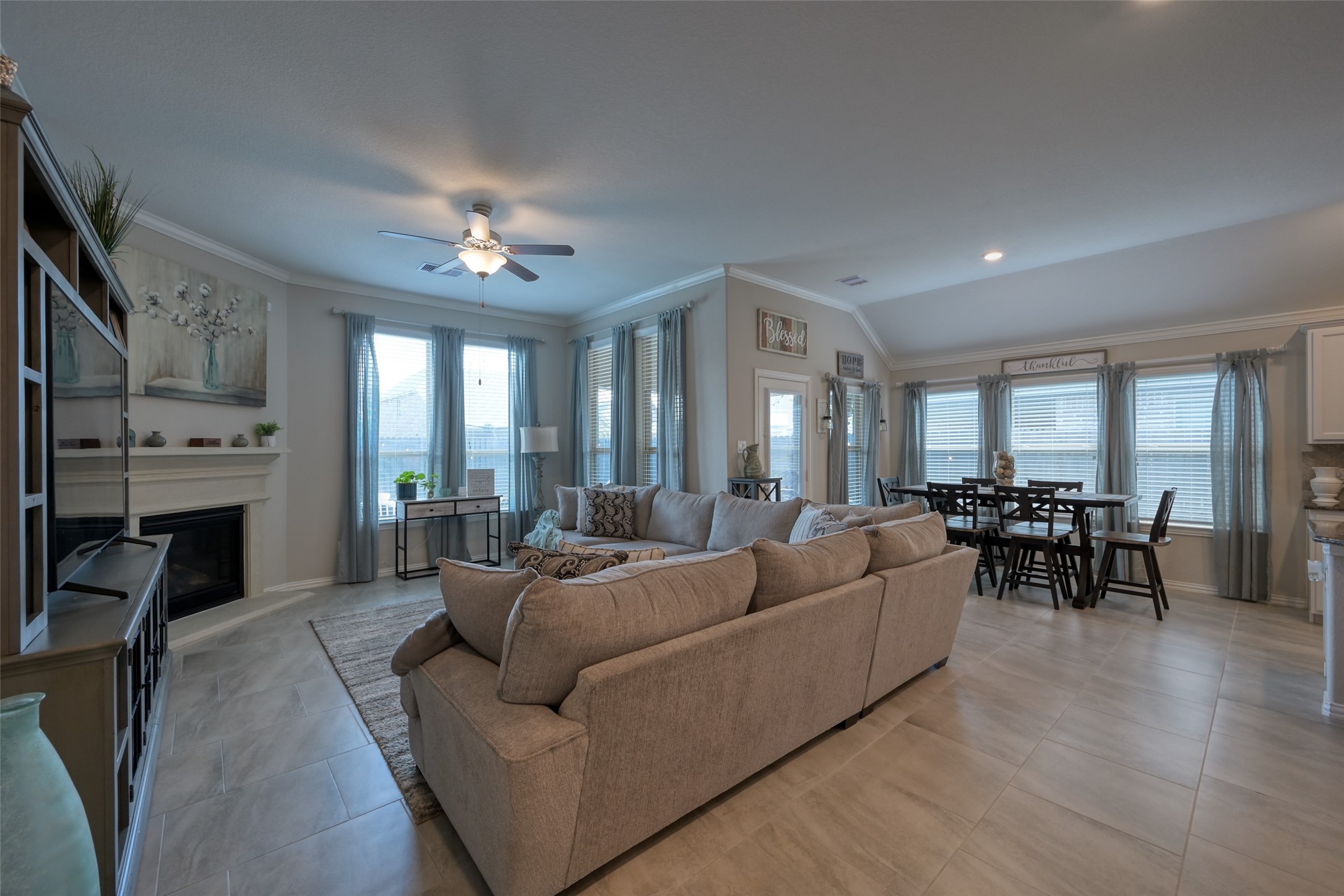 3465 Stablewood Grove Lane Spring, TX 77386 - Photo 8 of 50 a living room with furniture a dining table and a fireplace