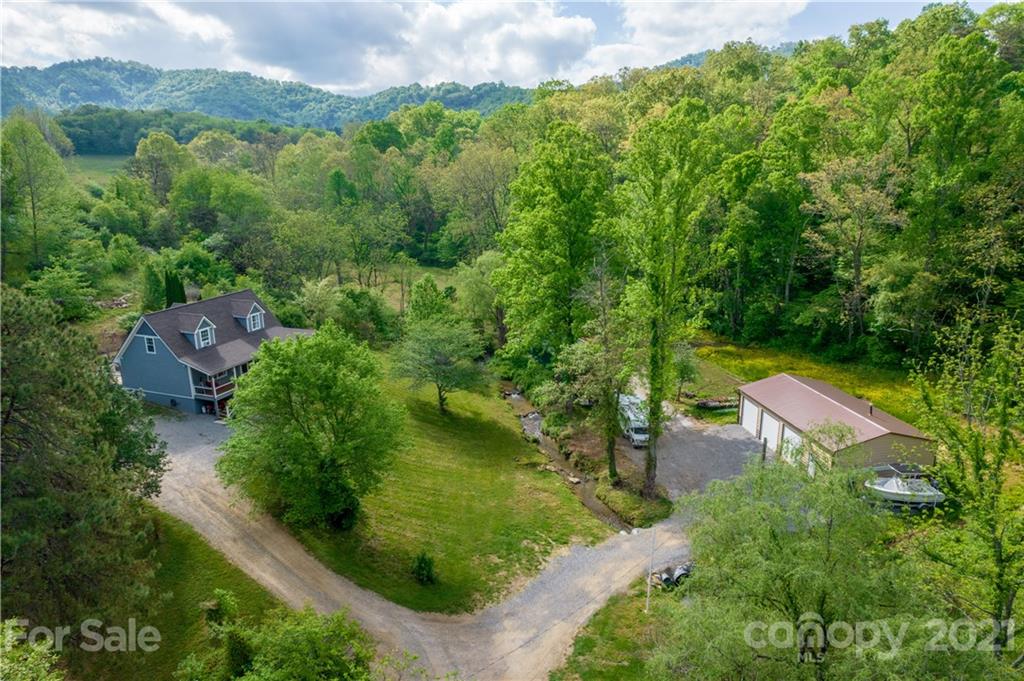 301 Fowler Lane Clyde, NC 28721 - Photo 2 of 47 an aerial view of a house with a yard