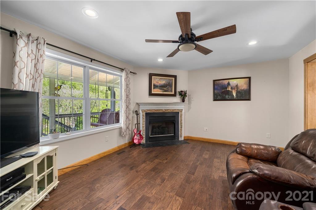 301 Fowler Lane Clyde, NC 28721 - Photo 11 of 47 a living room with furniture a flat screen tv and a fireplace