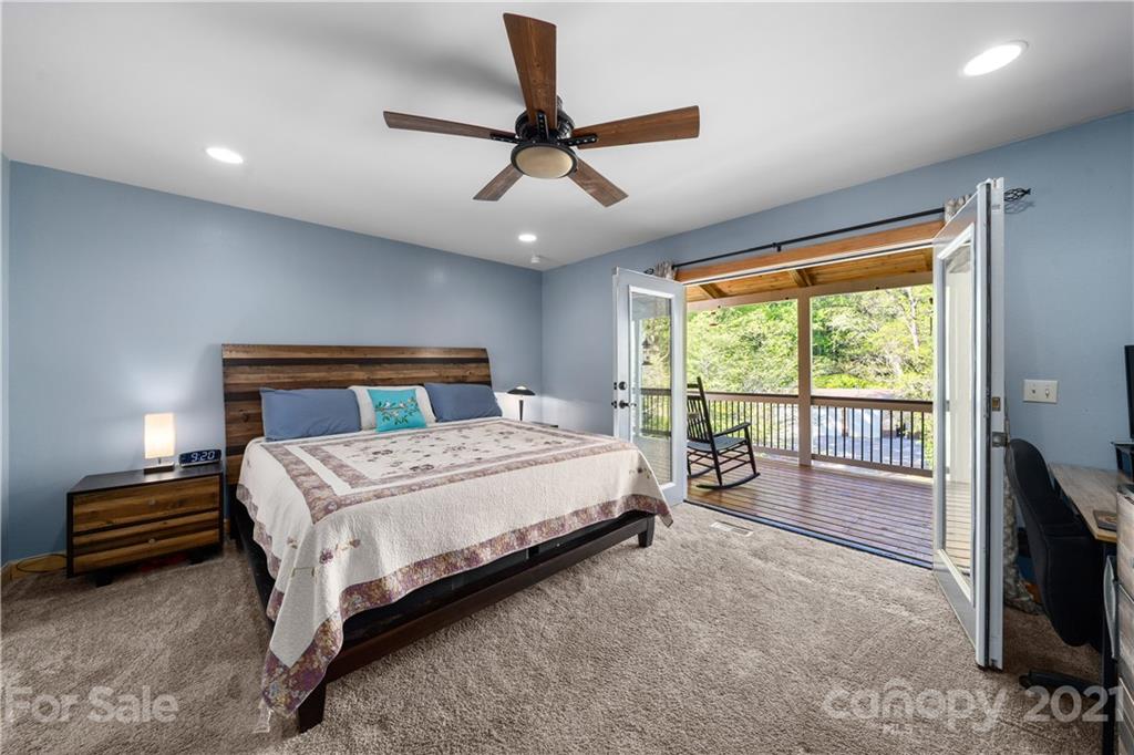 301 Fowler Lane Clyde, NC 28721 - Photo 12 of 47 a bedroom with a bed and a tv