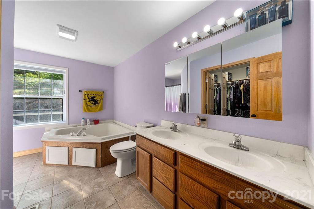 301 Fowler Lane Clyde, NC 28721 - Photo 14 of 47 a bathroom with a sink double vanity and a bathtub