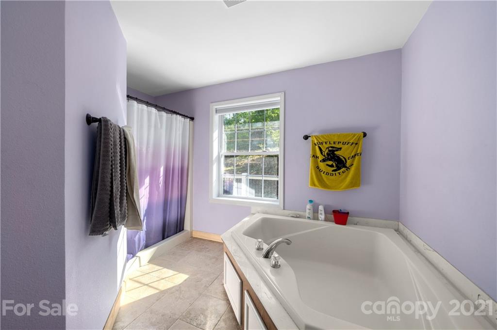 301 Fowler Lane Clyde, NC 28721 - Photo 15 of 47 a bathroom with a tub sink and a window