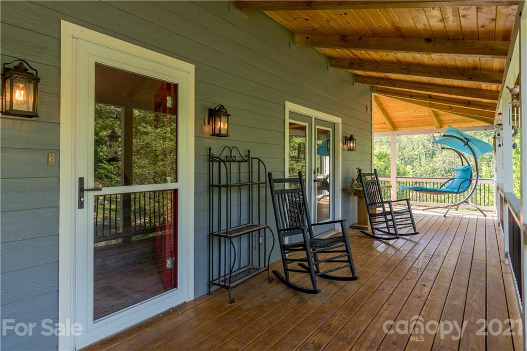 301 Fowler Lane Clyde, NC 28721 - Photo 18 of 47 a view of a balcony with wooden floor and iron stairs