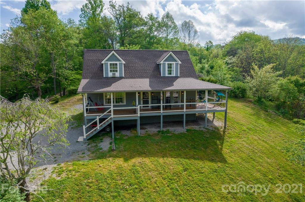 301 Fowler Lane Clyde, NC 28721 - Photo 19 of 47 an aerial view of a house with swimming pool next to a yard