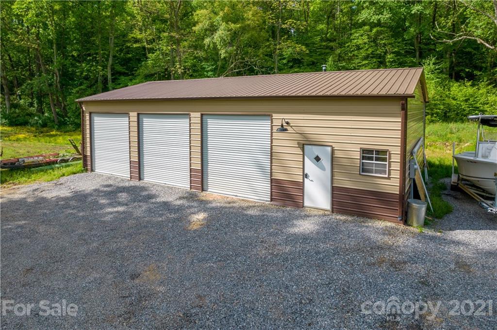301 Fowler Lane Clyde, NC 28721 - Photo 4 of 47 a view of a house with a yard and garage