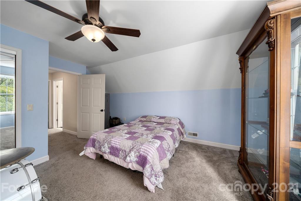301 Fowler Lane Clyde, NC 28721 - Photo 33 of 47 a bedroom with a bed chandelier and a window