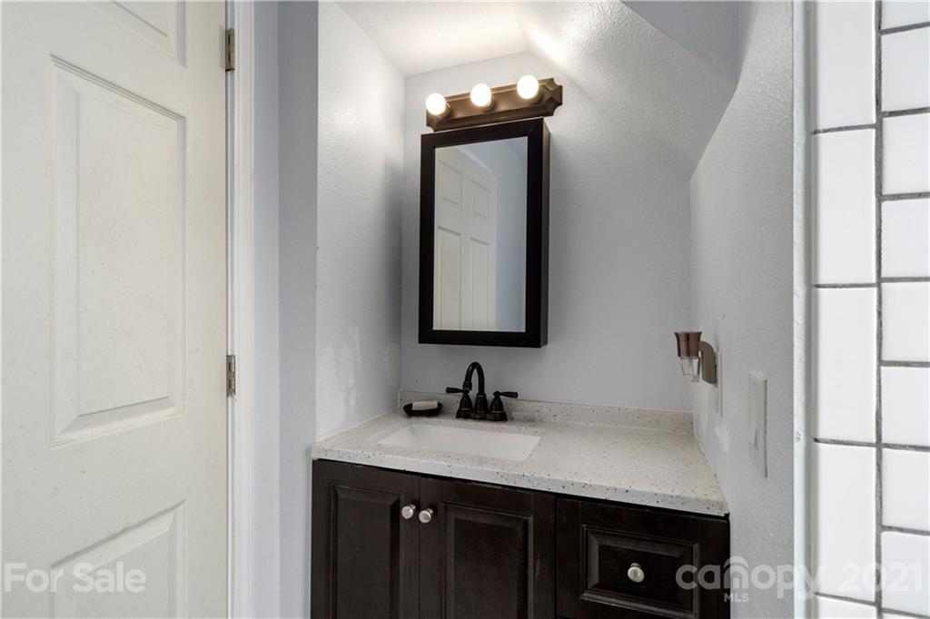 301 Fowler Lane Clyde, NC 28721 - Photo 35 of 47 a bathroom with a sink vanity granite and a mirror