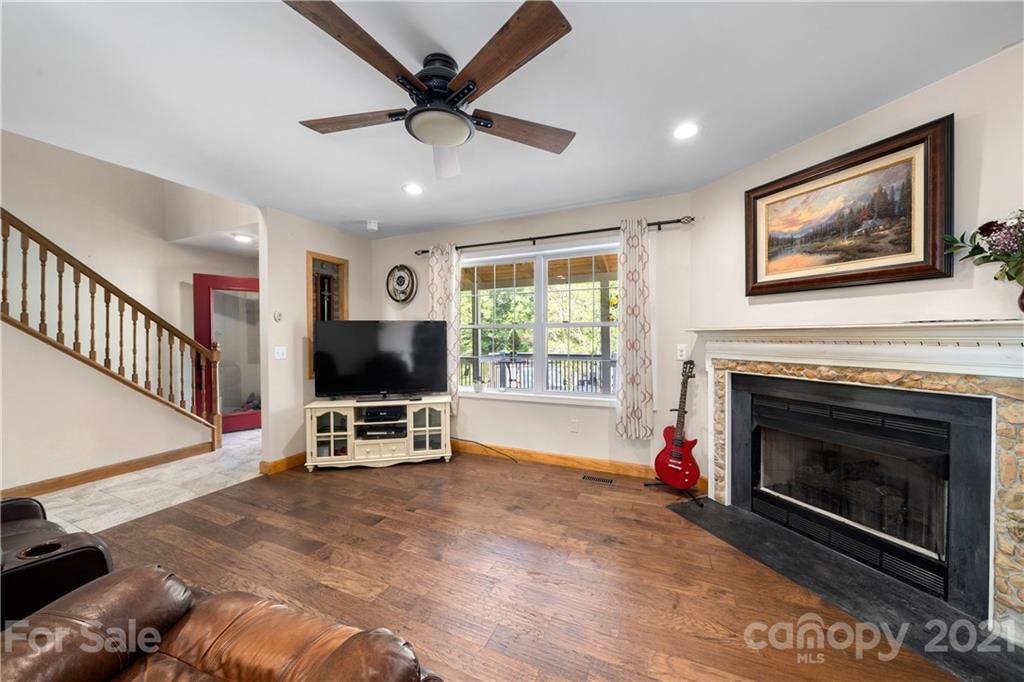 301 Fowler Lane Clyde, NC 28721 - Photo 5 of 47 a living room with furniture a window and a fireplace