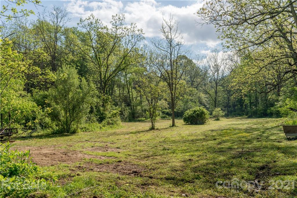 301 Fowler Lane Clyde, NC 28721 - Photo 42 of 47 a backyard of a house with lots of green space and trees