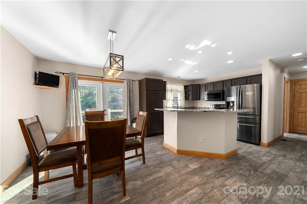 301 Fowler Lane Clyde, NC 28721 - Photo 8 of 47 a view of a dining room with furniture large window and wooden floor