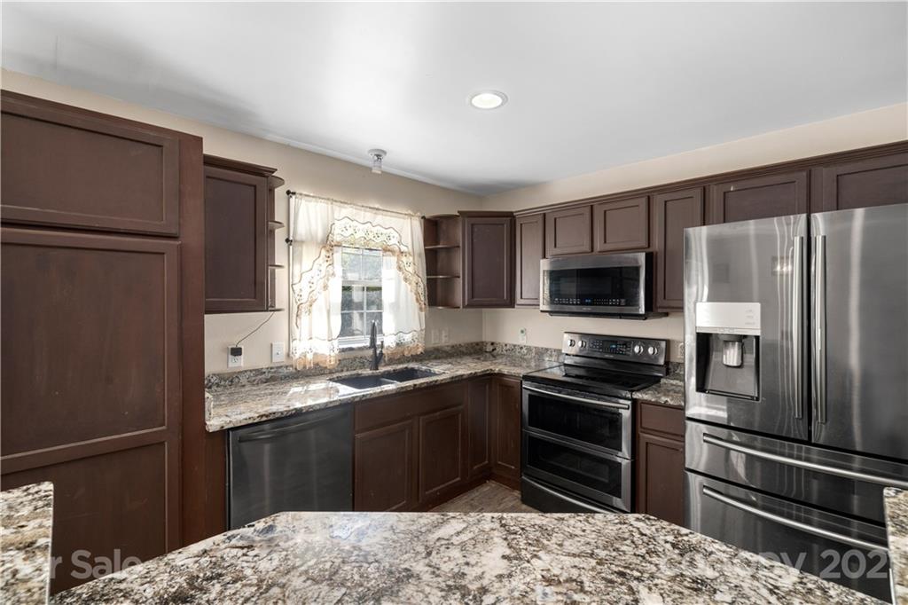 301 Fowler Lane Clyde, NC 28721 - Photo 10 of 47 a kitchen with a sink stainless steel appliances and refrigerator