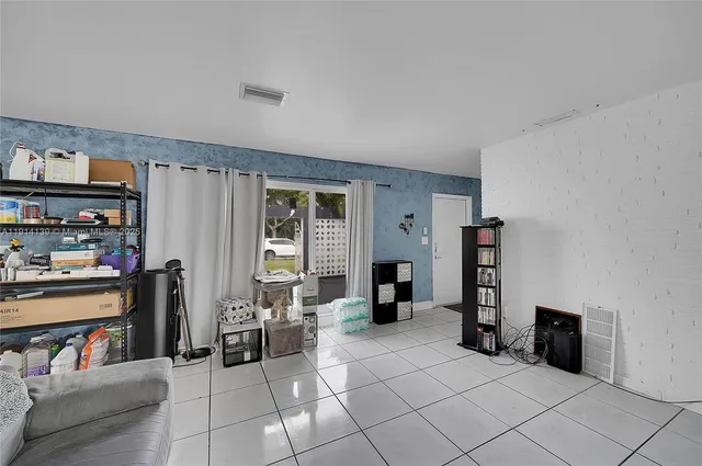 a room with furniture a flat screen tv and a window