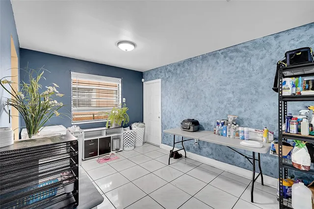 a living room with furniture and a dining table