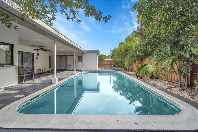 a view of a house with backyard sitting area and porch