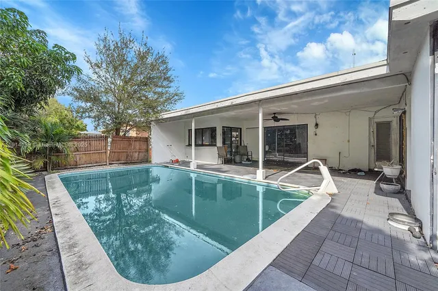 a living room filled with furniture and a large window