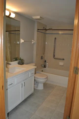 a bathroom with a double vanity sink toilet and shower