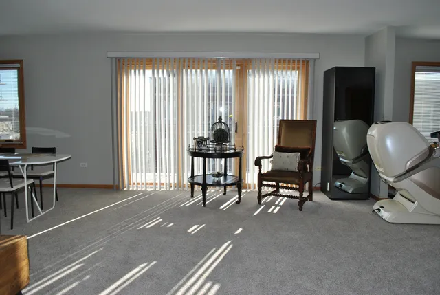 a view of a livingroom with workspace and a window