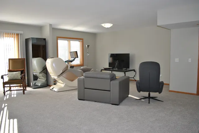 a living room with furniture and a mirror