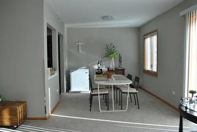 a dining room with furniture and window