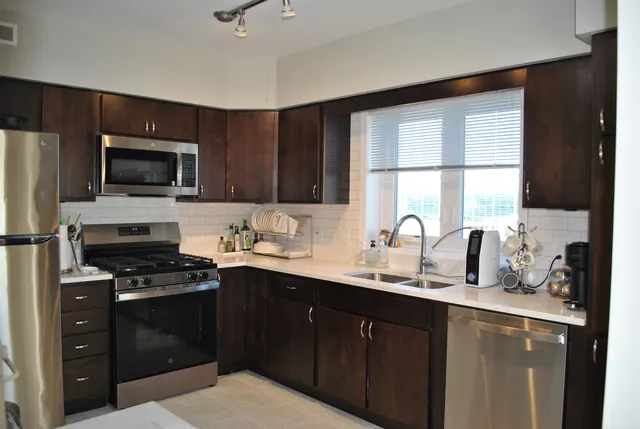 a kitchen with a sink stove and microwave