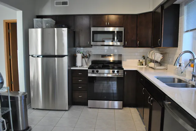 a kitchen with a refrigerator and a sink