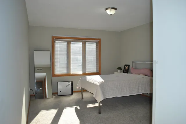 a bedroom with a bed and a table