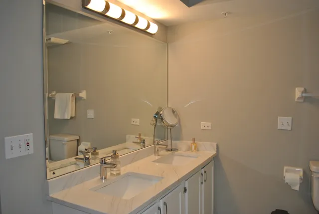 a bathroom with a sink vanity and a mirror