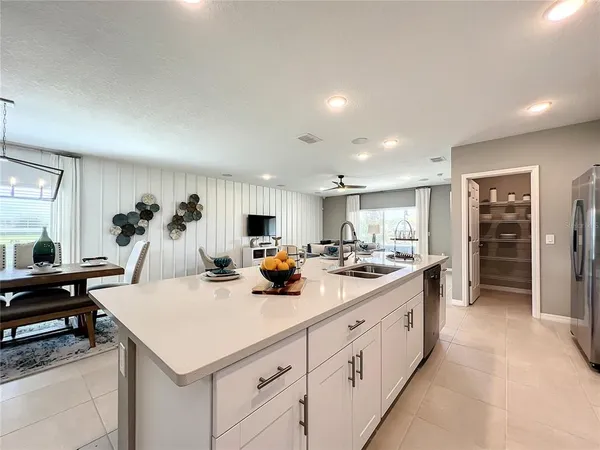 a kitchen with stainless steel appliances granite countertop a sink a stove and a refrigerator