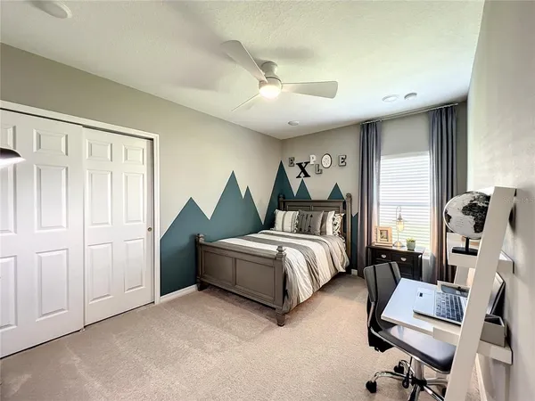 a bedroom with a bed and a chandelier